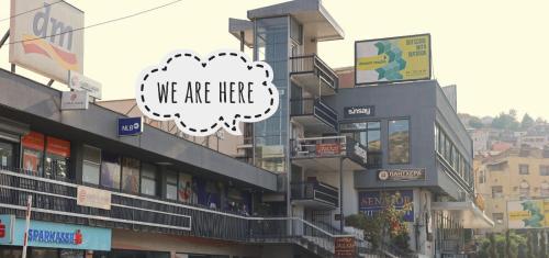 a building with a sign that says we are here at Apartment Friends in Veles