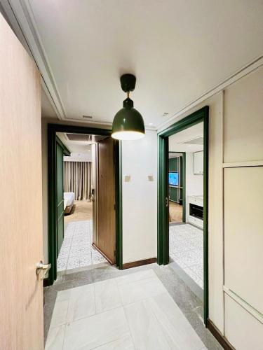 a hallway with green doors and a ceiling at The Quarter Chaophraya by UHG in Bangkok