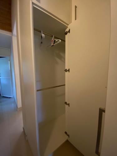 a closet with a door and two pairs of shoes at La Vie Pearl in Kadawatha