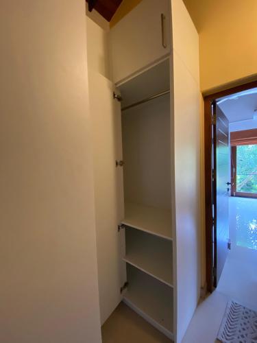a walk in closet in a room with a window at La Vie Pearl in Kadawatha