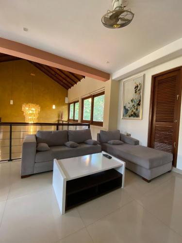 a living room with a couch and a coffee table at La Vie Pearl in Kadawatha