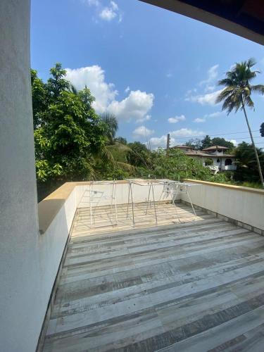 a boardwalk with chairs on top of a building at La Vie Pearl in Kadawatha