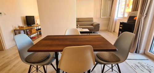 a dining room with a wooden table and chairs at CityHeart Apartment in Nikšić