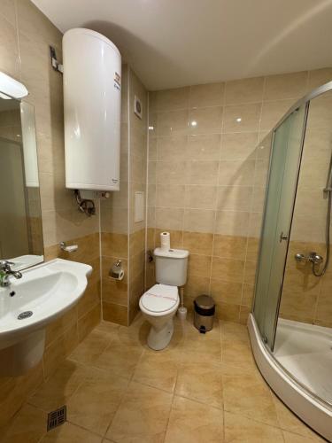 a bathroom with a toilet and a sink and a shower at VP Palazzo Nesebar in Nesebar