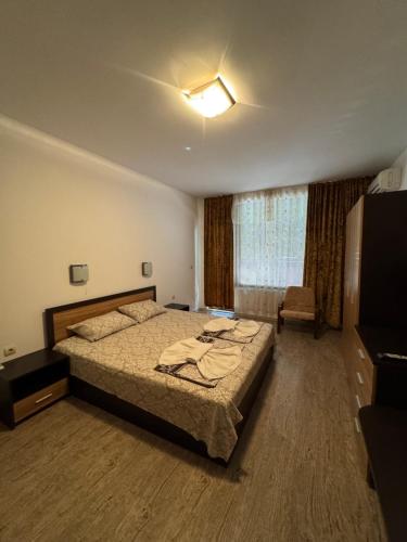 a bedroom with a large bed and a window at VP Palazzo Nesebar in Nesebar