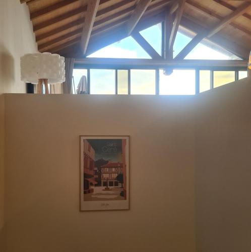 a picture on a wall in a room with a window at Aubié superbe propriété pour 20 avec piscine in Latouille-Lentillac