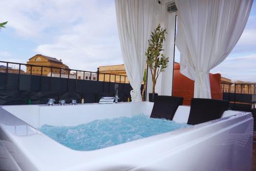 a hot tub on the roof of a building at Teatro Massimo Terrace relax suite in Palermo