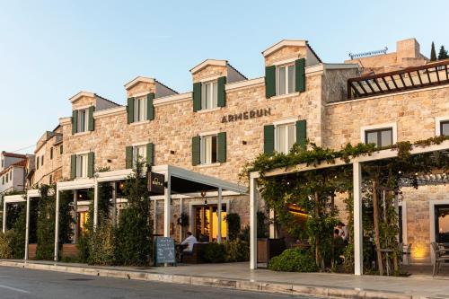 a large brick building with windows on a street at Armerun Heritage Hotel & Residences in Šibenik