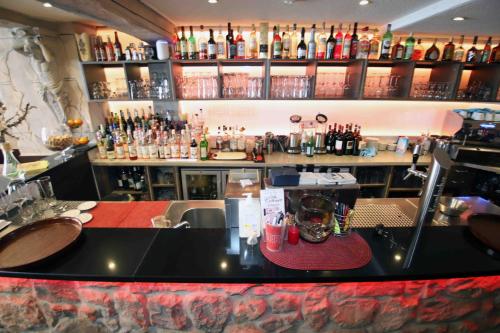 a bar with a counter and a lot of bottles at Pension Villa Colosseo im Herzen von Meiningen in Meiningen