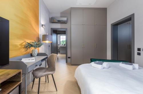 a bedroom with a bed and a desk and a chair at Villa St Hedonist by Villsy in Poljane