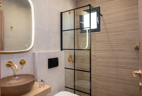 a bathroom with a sink and a toilet and a shower at Glafkos house with pool near the beach in Daratso