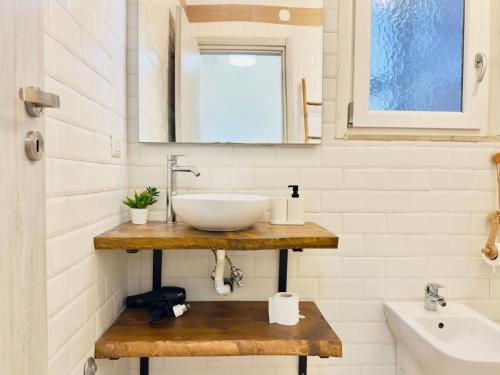 a bathroom with a sink and a mirror at Demetra Seafront Apartment - Parking & Pool in Castel Volturno