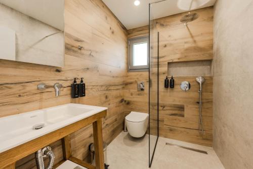 a bathroom with a shower and a sink and a toilet at Emerald Project in Limenas