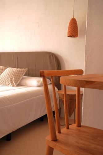 a living room with a couch and a table and a chair at Ses Terrisses Hotel in Palafrugell