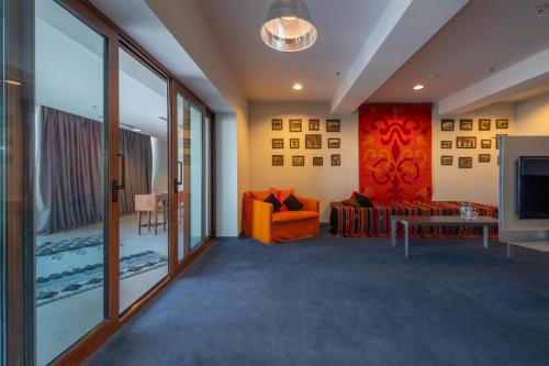 a living room with a couch and a tv at Kabadoni Boutique Hotel in Sighnaghi