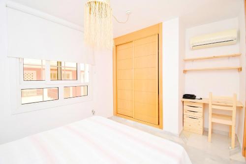 a bedroom with a wooden door and a desk at Expoholidays - Galeon 46 Puerto Deportivo in El Ejido