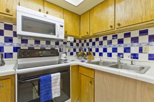 a kitchen with a sink and a microwave at Sea Vista in South Padre Island