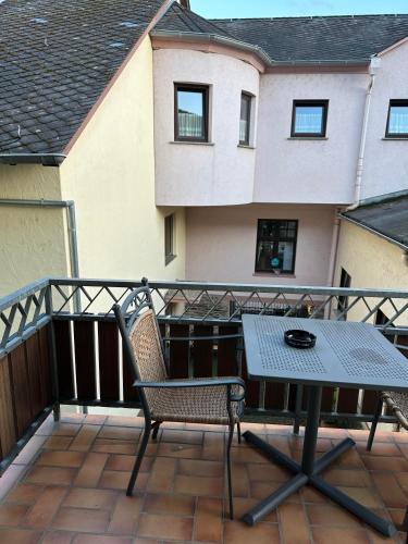 a patio with a table and chairs on a balcony at Lesura Ferien- Apartment in Lieser
