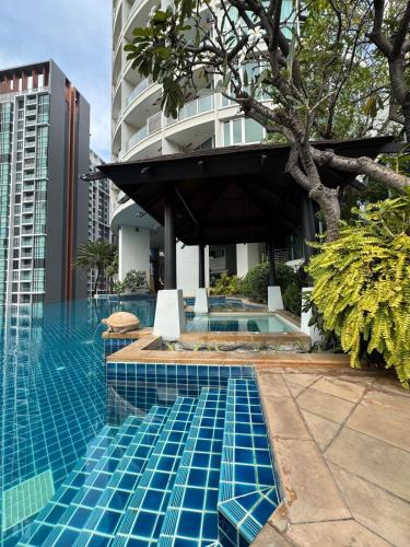 a swimming pool in front of a building at Super City View Room, Swimming Pool,Gym,150m walk to BTS in Bangkok