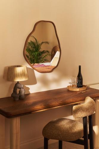a mirror on top of a wooden table with a chair at Crafted at Powdermills in Battle