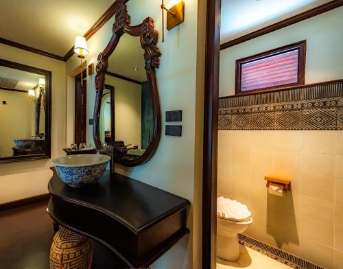 a bathroom with a sink and a mirror at Sengphachanh Heritage Boutique in Luang Prabang