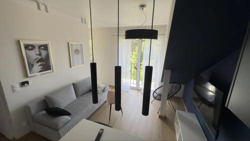 a living room with a couch and a table at Apartament Kwiatkowskiego, self check-in, parking in Rzeszów