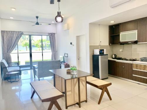 a kitchen and living room with a table and chairs at Deco Home @ Imago The Loft in Kota Kinabalu