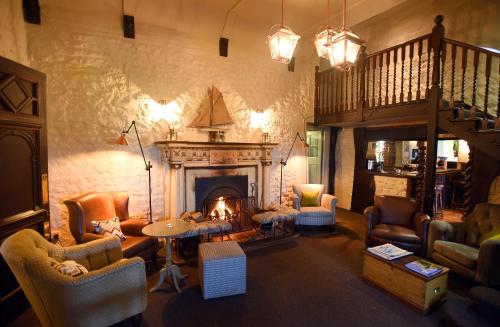 a living room filled with furniture and a fireplace at The Lifeboat Inn in Hunstanton