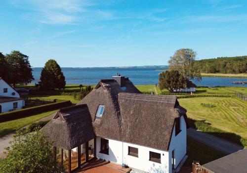 an aerial view of a house with a thatched roof at Ferienwohnung Laran - direkt am Bodden in Ralswiek in Ralswiek