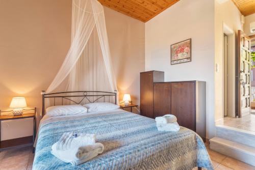 a bedroom with a bed with towels on it at Christianna studios in Nikiana