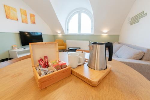 a coffee maker on a table in a living room at Luma Terra Prague Hostel in Prague