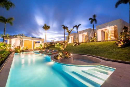 a swimming pool in front of a house at Asri Village Two in Uluwatu