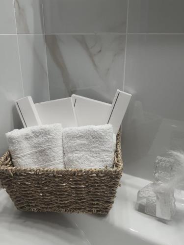 a basket of towels sitting on a counter in a bathroom at Galazio suites 1 Seaside in Salamina