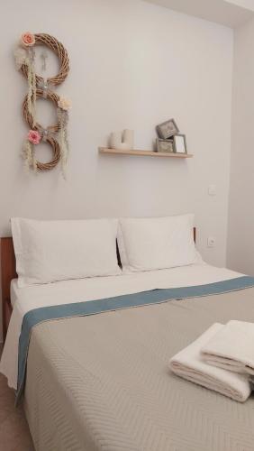 a bedroom with a bed with towels on it at Galazio suites 1 Seaside in Salamina