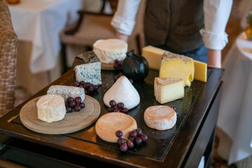 a tray of different types of cheese and pastries at Lucknam Park Hotel in Chippenham