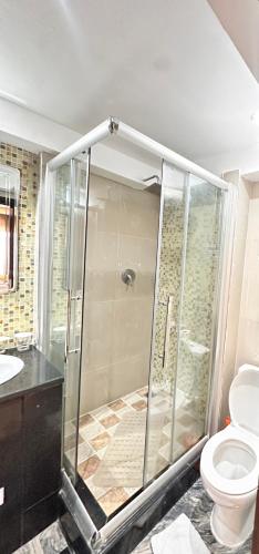 a bathroom with a shower and a toilet at Golden Tulip Hotel Port Harcourt -GTPH in Port Harcourt