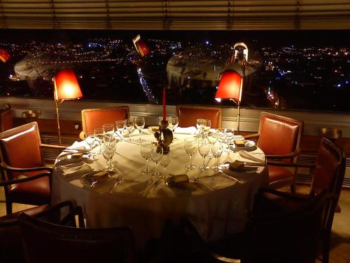 a table with wine glasses and a view of a city at Hotel Miradouro in Porto