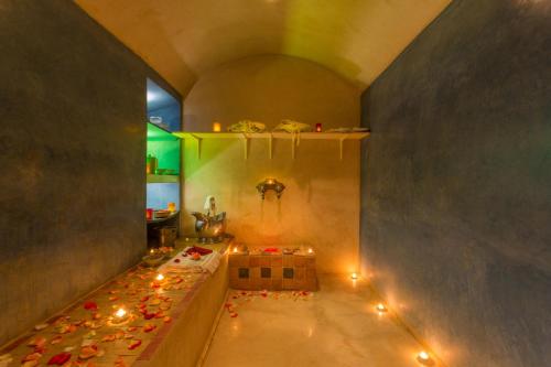 a room with a tub with candles on the floor at Riad Malika in Marrakesh