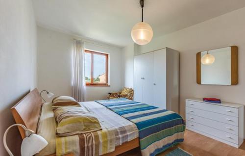 a bedroom with a bed and a dresser in it at Villa Leggiero in Fažana
