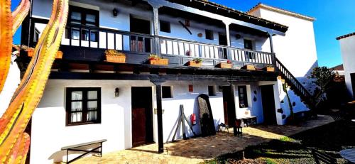 a white house with a balcony and a board at Casa Rural Isaítas in Pájara