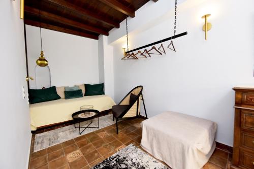 a room with a bed and a table and a chair at Elaia-Fos in Rhodes Town