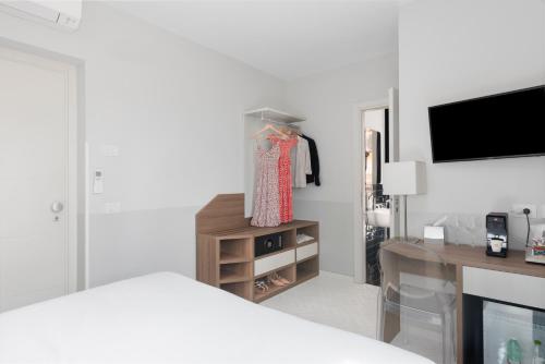 a bedroom with a bed and a desk and a tv at Palazzo Tasso in Sorrento