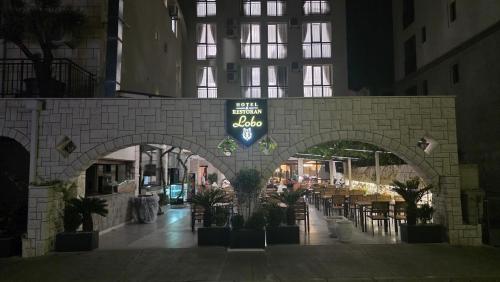 an archway in a building with tables and chairs at Hotel Lobo Budva in Budva