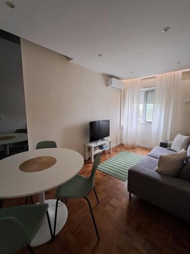 a living room with a table and a couch at Sweet Living Lisboa in Lisbon