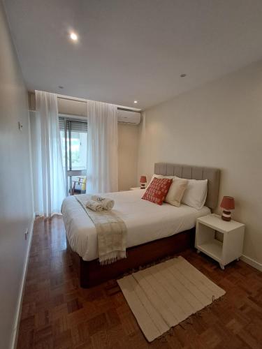 a bedroom with a large bed and a window at Sweet Living Lisboa in Lisbon