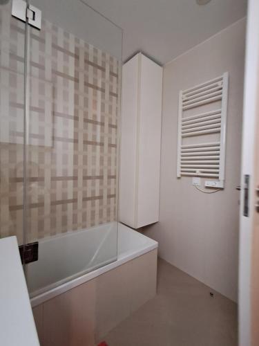 a white bathroom with a tub and a window at Sweet Living Lisboa in Lisbon