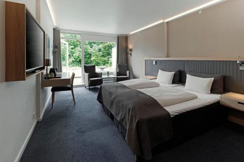 Postel nebo postele na pokoji v ubytování Frederiksdal Sinatur Hotel & Konference