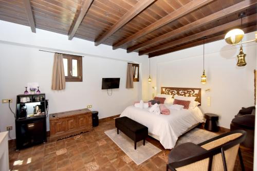 a bedroom with a bed and a living room at Elaia-Fos in Rhodes Town