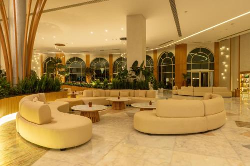 a lobby with couches and tables in a building at Cleopatra Sidi Heneish in Marsa Matruh