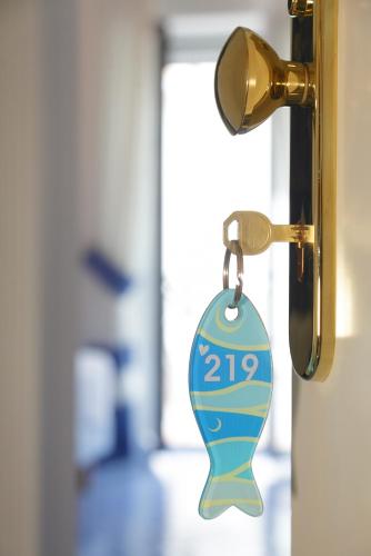 a key chain hanging from a door with the number at Hotel Aurora in Sperlonga